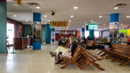 Belize City, Belize - November, 18, 2019. Passengers waiting for their flights inside international Philip S W Goldson Airport.のeditorial素材