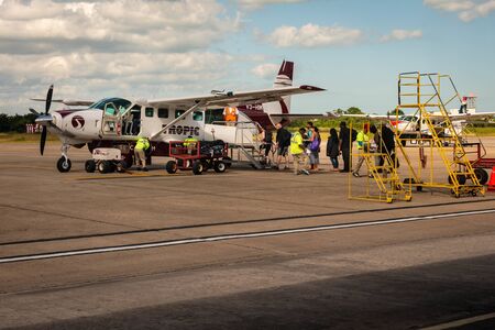 Belize City, Belize - November, 18, 2019. Passengers board the small Tropic Air Airline departing from Philip S W Goldson Airport.のeditorial素材