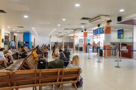Belize City, Belize - November, 18, 2019. Passengers waiting for their flights inside international Philip S W Goldson Airport.のeditorial素材