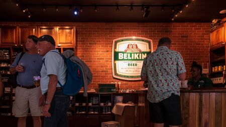 Belize City, Belize - November, 18, 2019. Passengers enjoying Belikin Beer while they wait for their flights out of  Philip S W Goldson Airport.のeditorial素材