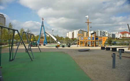 Children playground on yard in public park. Urban neighborhood childhood