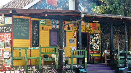 View of house in Metelkova in city center, artistic district with colored buildings, graffitti, sculptures and mosaics, sunny dayのeditorial素材
