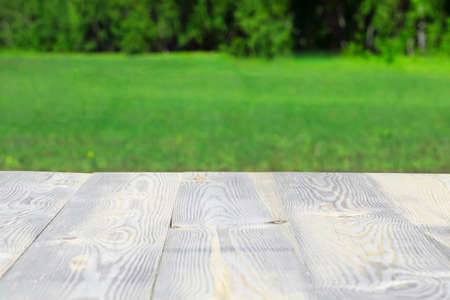 Nature light blur background, Wood table outdoor in garden or park in spring and summer with space for textの写真素材