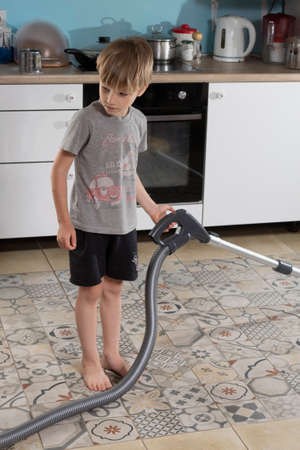 boy helps his mother, cleaning floorの写真素材