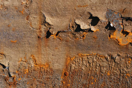 Brown painted rusty metal surface with streaks of rust. cracked rusty corrosion, oxidized iron...