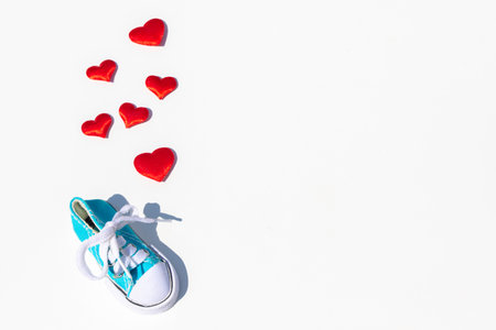 baby sneakers with hearts are isolated on white background with copy space. Concept of pregnancy, newborn, baby waitingの写真素材
