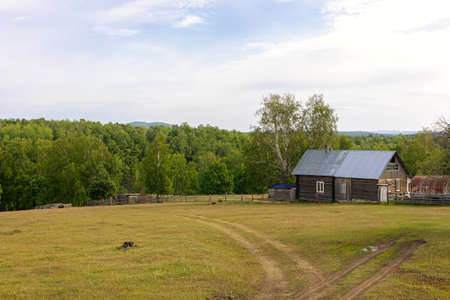 poor old cottage with stable. Farm rural landscape in summer.
