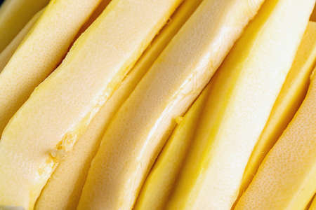 peeled strips of zucchini stacked in row close-up. Natural texture