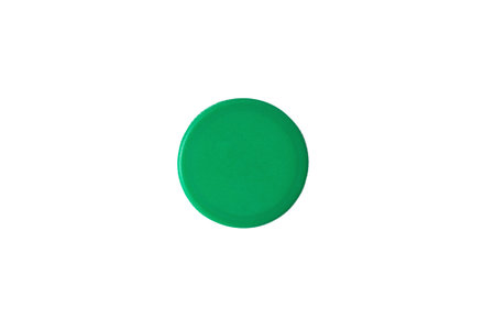 Green plastic bottle cap isolated on white background. Top view.