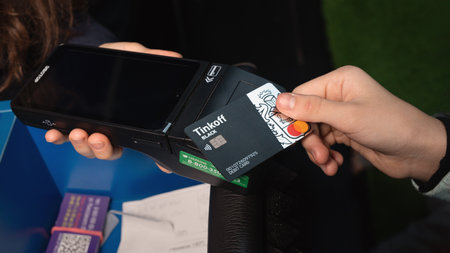 Close up of payment being made with contactless debit card with wireless technology. Omsk, Russia,...