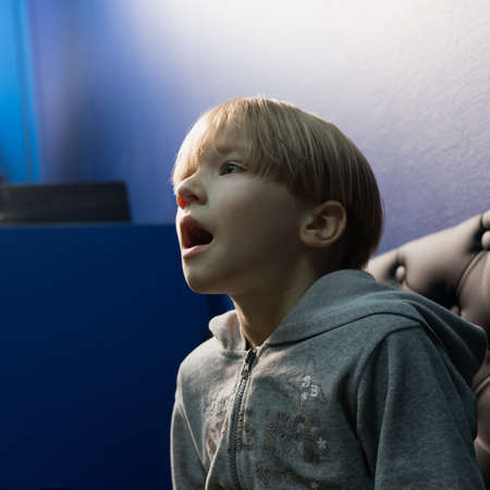 portrait of little impressed boy with open mouth locking up.の写真素材