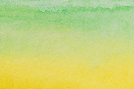 Abstract watercolor hand painted green yellow paper background.の写真素材