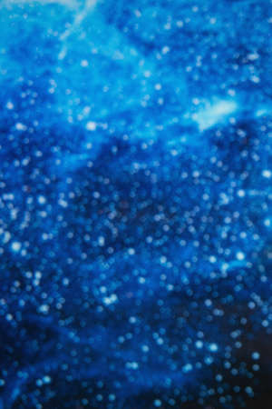 blue water background blurred with air bubbles and light spotsの写真素材