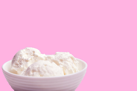 white bowl with white ice cream on a pink background. front view. place for your text
