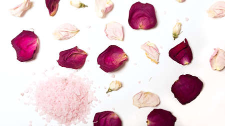 Pink himalayan sea bath salt for healthy spa relaxation on white background. Top view