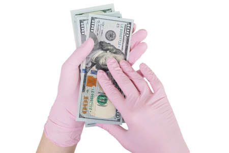 concept of paid medicine. gloved hands holding a pack of dollars