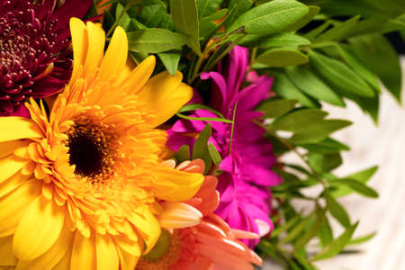 Close-up of large beautiful orange gerbera flower in colorful bouquet of flowers. Gift for holiday or poster for store.の写真素材