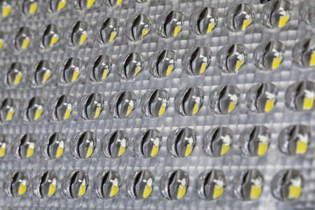 Background of glass glass transparent of LED lamp or panel with yellow light emitting diodes...