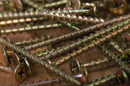 background of scattered yellow metal self-tapping screws