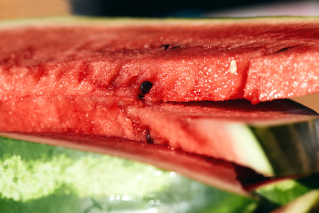 Close up of fresh ripe red watermelon fruit slices. Summer thirst-quenching snack.