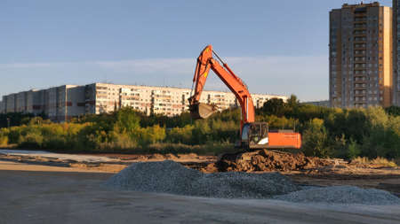 Articulated wheeled crawler excavator or bulldozer on construction site of city highway or road. Heavy earth mover.の写真素材
