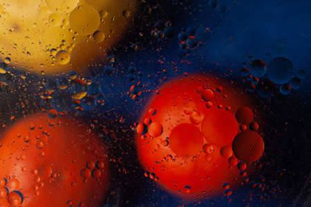 Colorful oil bubbles in water. Space, biology, phycics or chymistry abstract background.