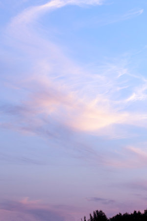 Romantic sunset sky background with soft clouds. Sunset light colors clouds in red, blue, pink and...