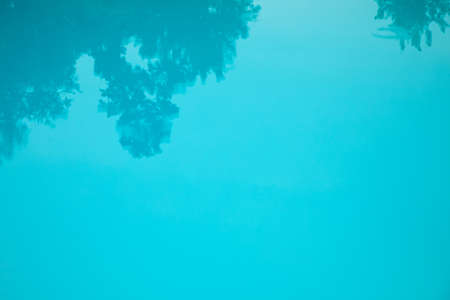 Natural background, blue water in the pool with tree shadowの写真素材