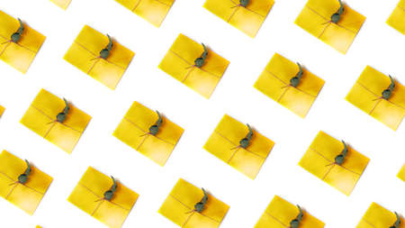 The yellow envelopes are tied by rope and decorated with a branch of dry eucalyptus on a white background, flat lay pattern. Top view, web bannerの写真素材