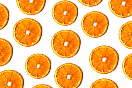 Flat lay pattern of dry orange slices isolated on white background. Top viewの写真素材