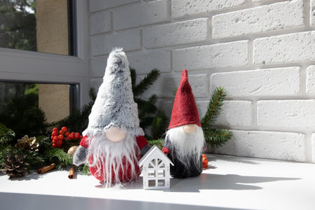 New Year, Christmas background. New Years decor on a white table with branches of a green Christmas tree, pine cones, gnomes. Front viewの写真素材