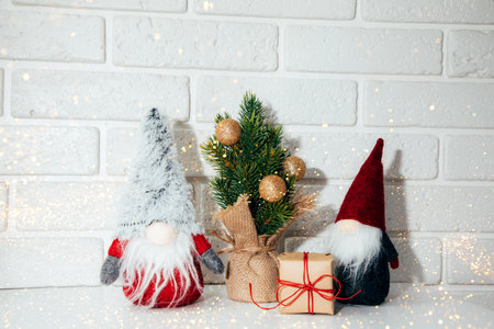 New Year, Christmas background. New Years decor in lights on a white table, green Christmas tree...