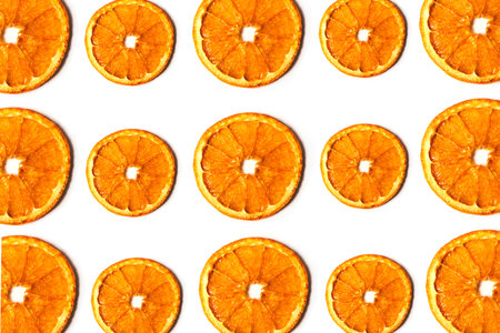 Flat lay pattern of dried orange slices isolated on white background. Top viewの写真素材
