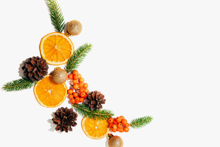 New Years, Christmas composition on a white background with branches of a green Christmas tree, pine cones and slices of dry orange. Flat layの写真素材