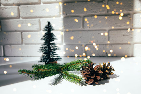 New Year, Christmas background. New Years decor on a white table, decorative fir, pine cones and green branches. Front viewの写真素材