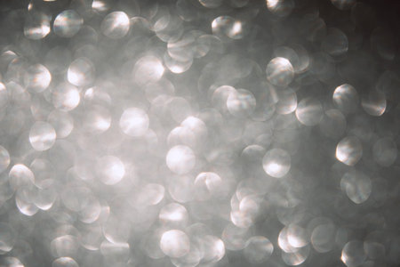 Shiny gray black blurred background for holiday design. Christmas abstract sparkles
