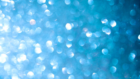Shiny light blue blurred background for holiday design. Christmas banner abstract textured glitterの写真素材