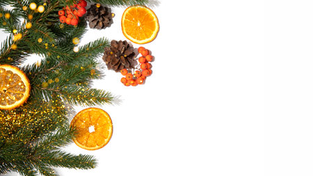 New Year, Christmas background banner. New Years decor on a white background with branches of a green Christmas tree, pine cones and slices of dry orange. Flat layの写真素材