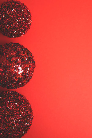 New Years, Christmas decor, red shiny balls on a red background. Flat layの写真素材