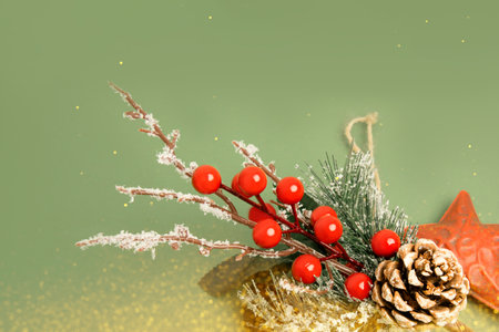 Christmas, New years decorations, red star, branch and ball in yellow lights on a green background. Top viewの写真素材