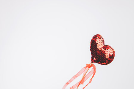Red heart in sequins on a white background. Valentines Day background. Top viewの写真素材