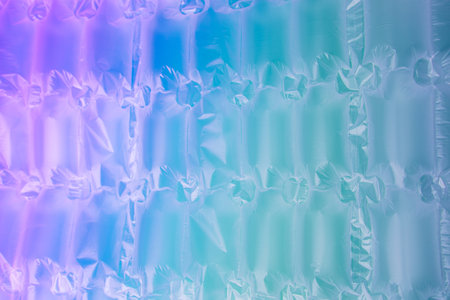 Background for design. Textured wrap for the safe packaging of fragile parcels with a neon gradient....