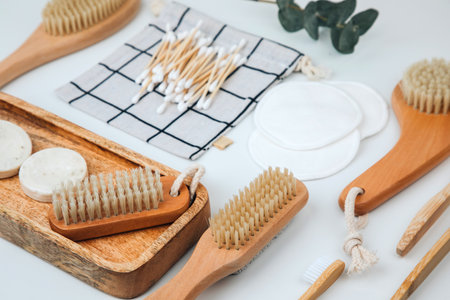 Set of wooden eco friendly devices. Brushes, washcloth and ear sticks, natural soap on a white...
