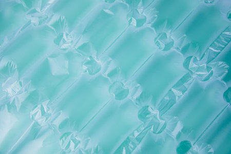 Background for design. Textured blue wrap for the safe packaging of fragile parcels. Non-degradable...
