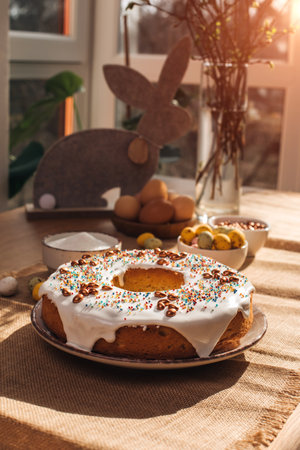 Round Easter cupcake decorative with white protein cream on a wooden table in the kitchen. Top view