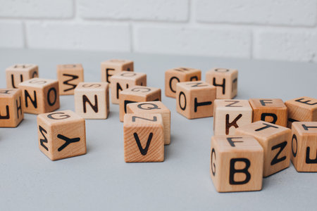 Wooden cubes with black letters on a gray table, close up. Cubes made of eco-friendly material. Front viewの写真素材