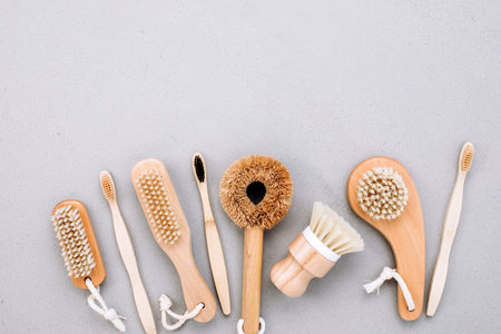 Set of brushes with wooden handles on a gray background, eco friendly products. Flat layの写真素材