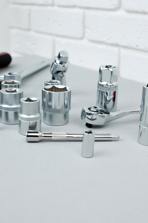 A set of working tools, a hammer, a screwdriver, sockets for an answer on a gray concrete background. Front viewの写真素材
