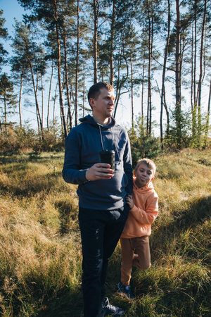 Happy fathers day. Dad and son on a walk in the forest in sunny weather. Family leisure. The father...