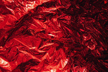 Abstract blurred crumpled foil red background, backdrop. Empty space for designの写真素材